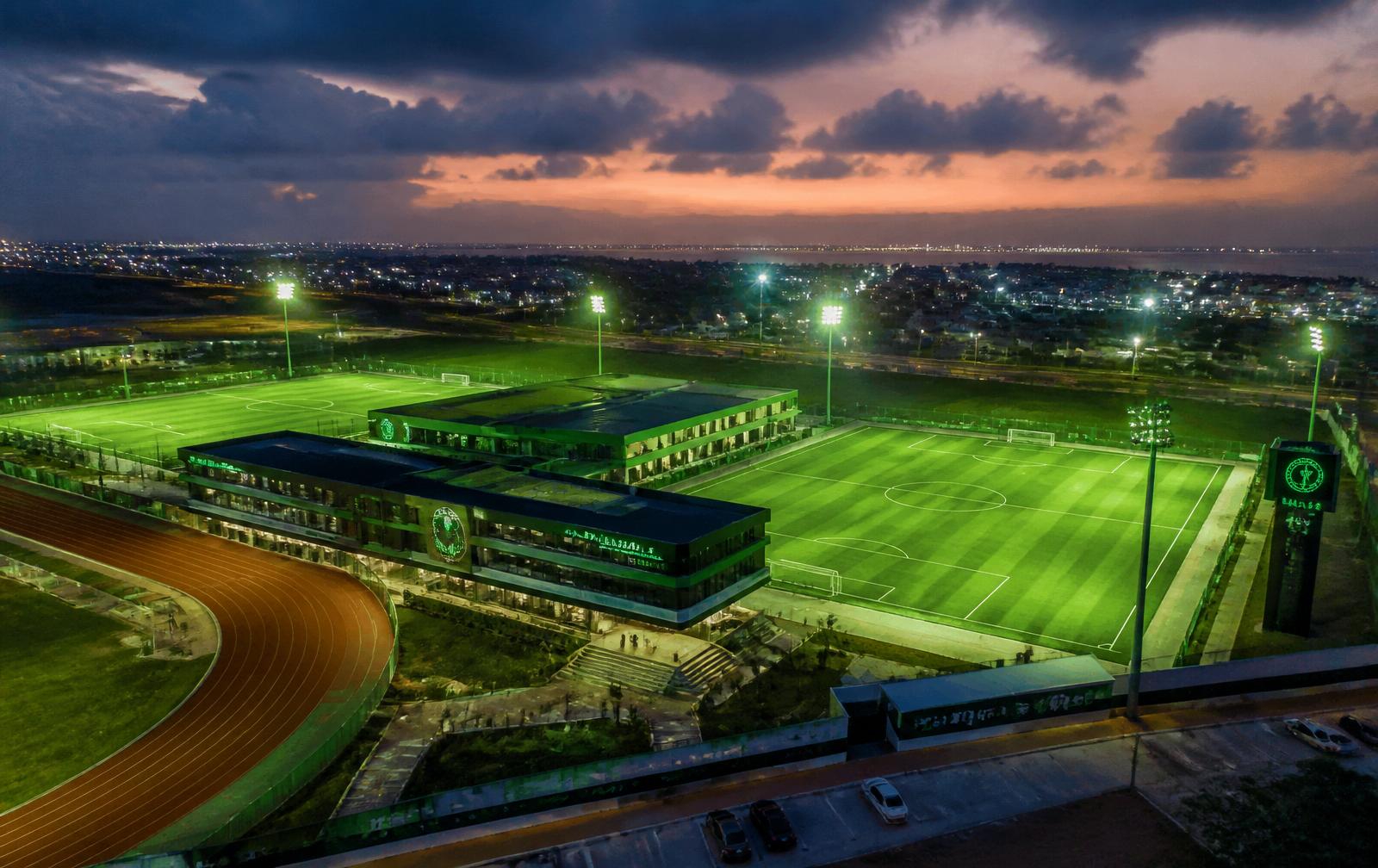 AMG Sports Academy training facility at dusk